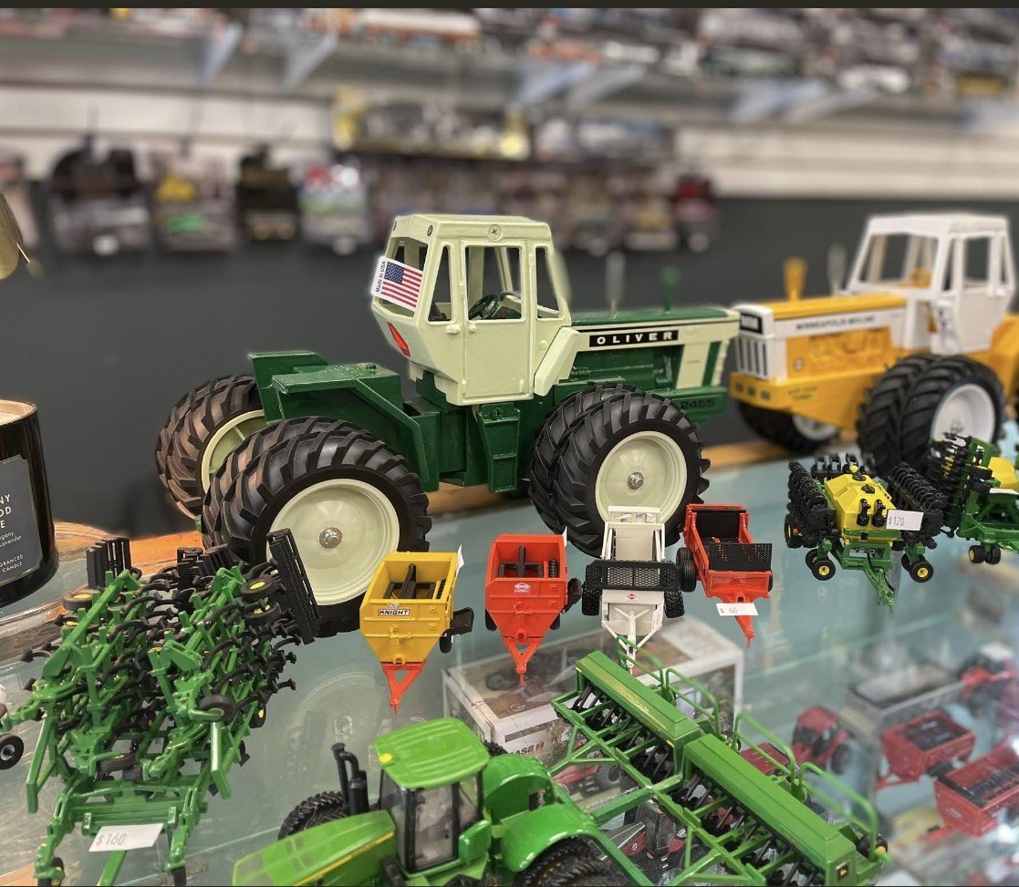 Shelves of 1/64 farm toys inside the store